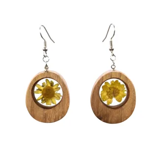 Handcrafted acacia wood earrings with a natural yellow flower inside, oval design and hand-finishing