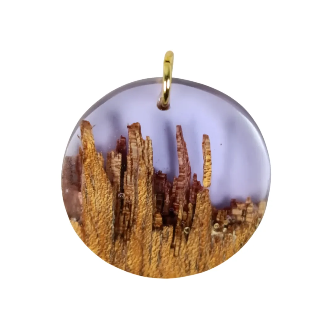 Round pendant in acacia and lilac resin, angled view with wood texture detail.