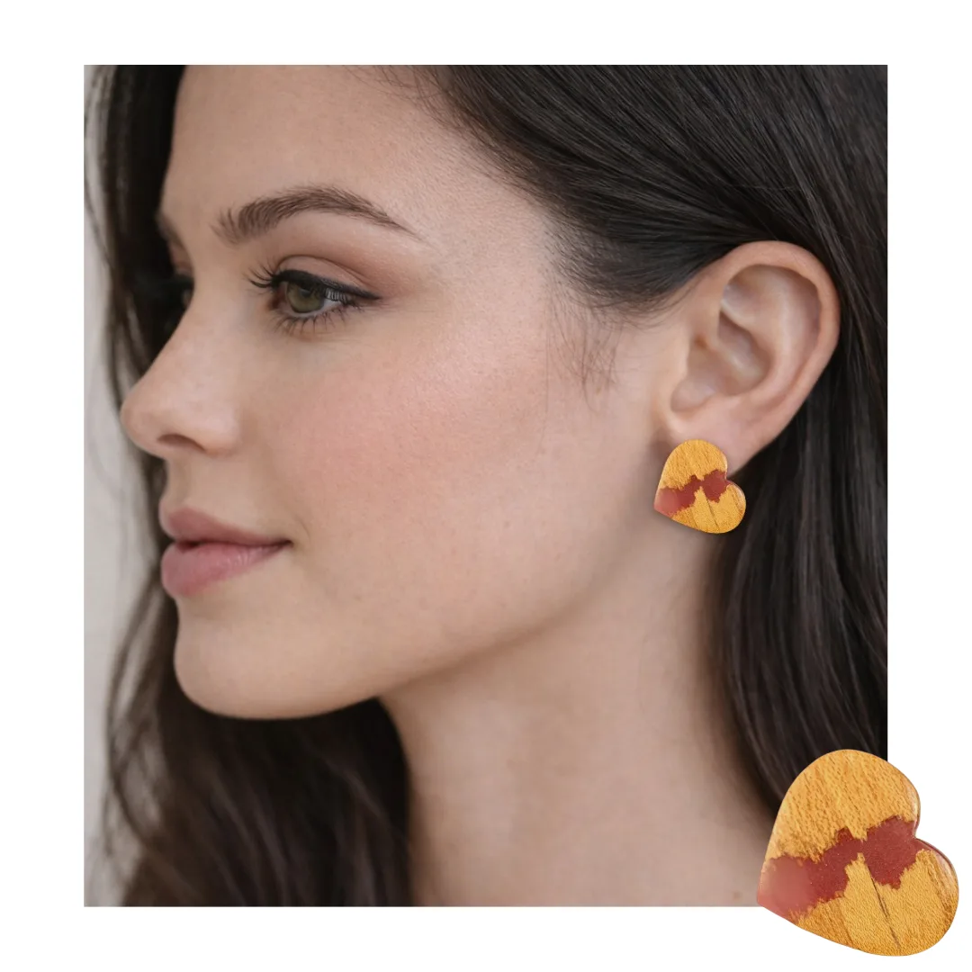 Model wearing heart earrings in wood and coral resin - left side view