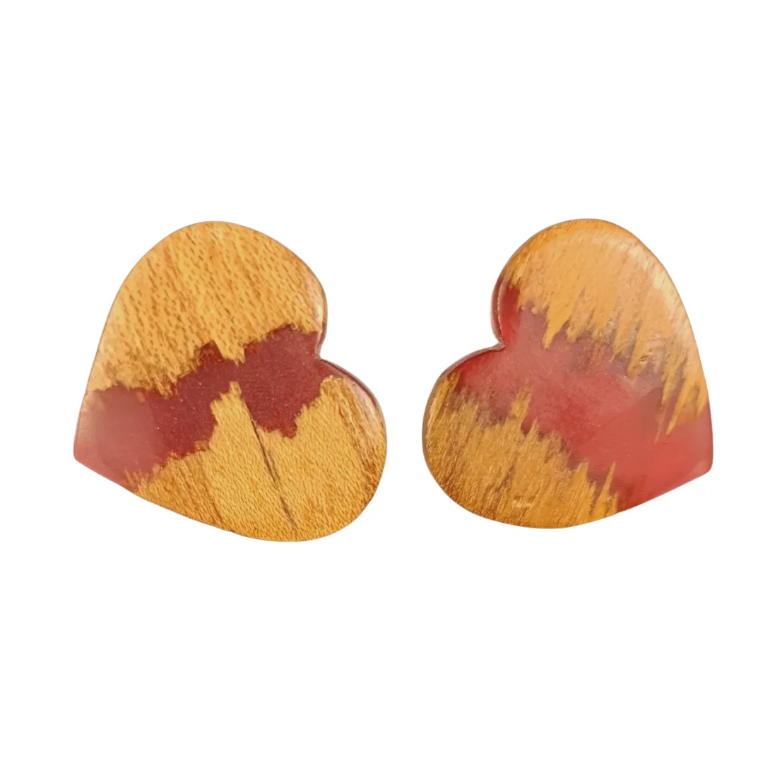 Heart earrings in natural wood and coral resin on a white background ( closer )