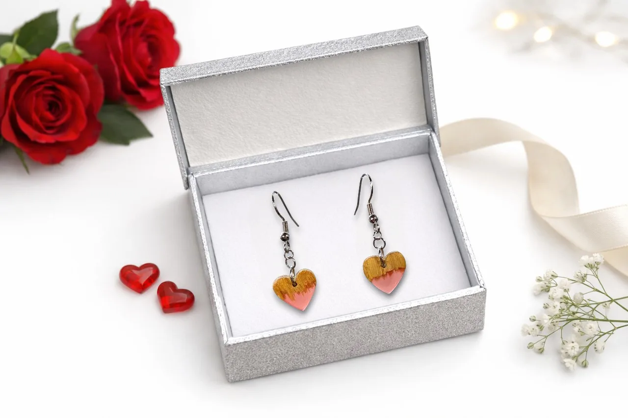 Brincos coração em madeira natural com faixa de resina rosa – coleção Cordis - numa caixa