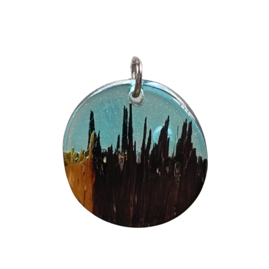Round pendant in natural wood and turquoise resin with nightscape effect
